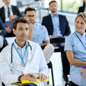 Male doctor attending healthcare seminar in convention center.