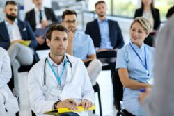 Male doctor attending healthcare seminar in convention center.